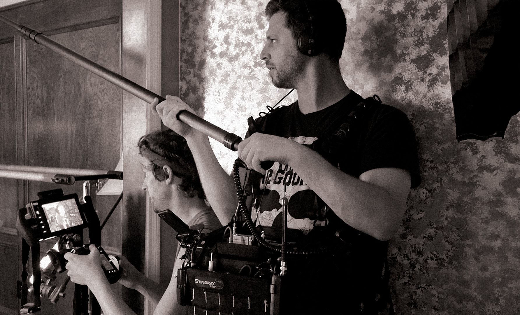The boom operator and the camera assistant in a hallway